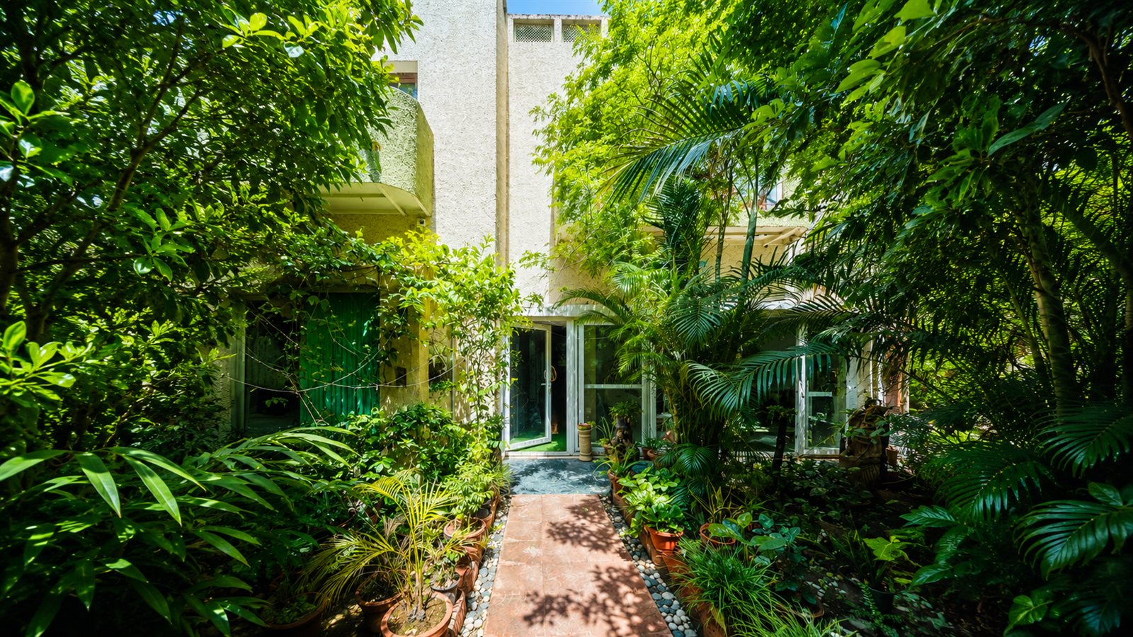 The lush green garden entrance of Dr. Bali's Bliss holistic health centre in Delhi