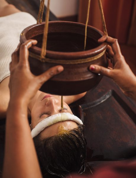 Caucasian woman having Ayurveda shirodhara treatment in India